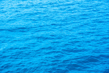 Obraz premium Top view of deep blue sea water surface with small ripples, aerial drone shot of turquoise ocean texture at island , abstract nature background 