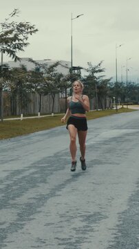Female runner pauses to catch her breath then resumes running