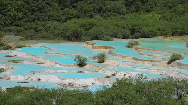 Rippling Turquoise Water in Travertine Pools under Gentle Breeze at Huanglong Scenic Area, Sichuan, China