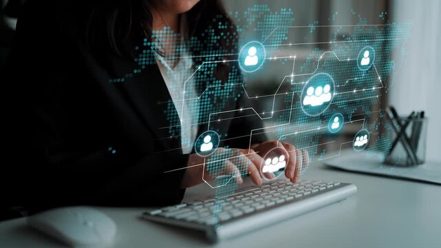 Professional woman typing on keyboard with virtual communication icons and digital network overlay in modern office workspace for business technology concept. Entropy.