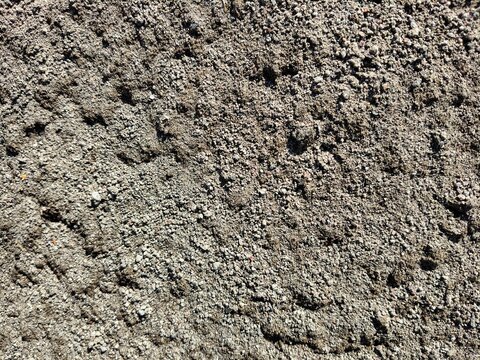 Close up texture of dry coarse sand and gravel on ground surface