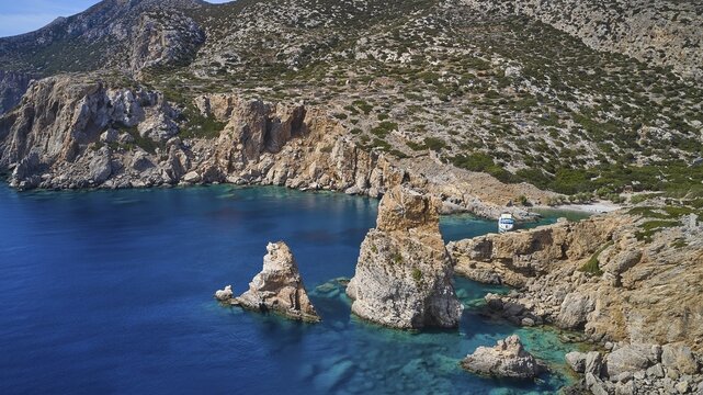 Palatia Beach, Palatia, cliff landscape with offshore rocks and a boat in the clear water, boat tour Saria, Saria Island, Karpathos, Dodecanese, Greek Islands, Greece