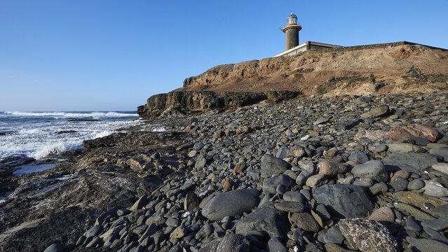 Lighthouse, building, rocky beach, surf, Wild South, Punta de Jandia, barren landscape, blue sky, few clouds, Fuerteventura, Canary Islands, Spain