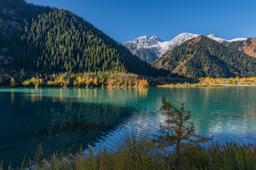 Naklejka premium The picturesque high-mountain Lake Issyk in the Almaty Region of southeastern Kazakhstan on an autumn morning.