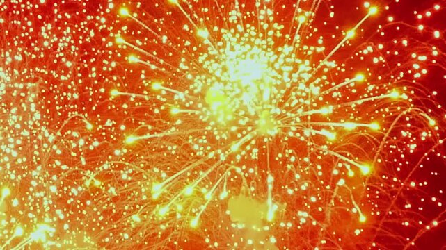 A shimmering cascade of gold erupts, painting the nighttime sky with fiery brilliance. Celebratory illuminations mark the Fourth of July amid the darkness.