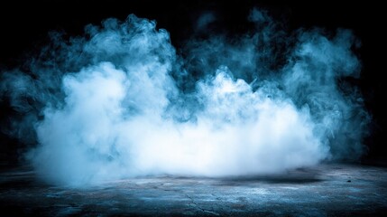Fototapeta premium Soft wispy light blue smoke or fog hovering over textured concrete ground against solid dark black background creates dramatic atmospheric effect