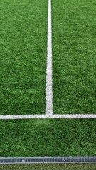 Obraz premium White football field line on green grass