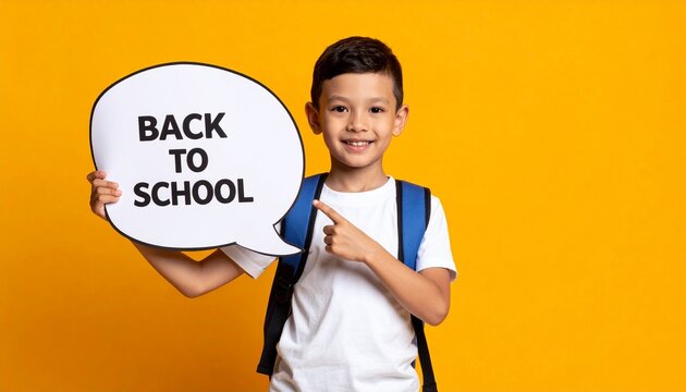 Little boy holding speech bubble with text BACK TO SCHOOL on orange background