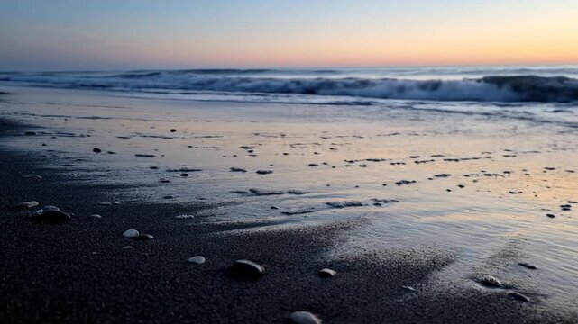 Golden hour glow paints the vast expanse of a serene ocean beach as gentle waves kiss the shore, leaving behind a tranquil mirror on the wet sand at dusk