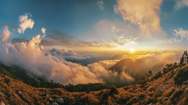 Panoramic view of a vibrant sunset over misty mountains and rolling hills