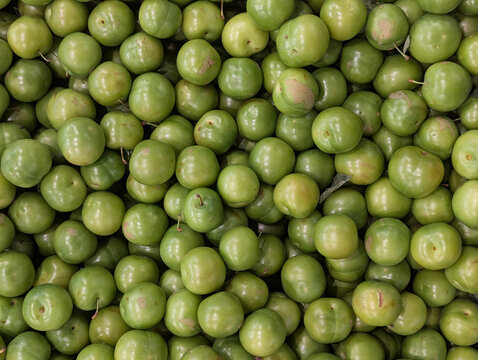 Pile of fresh green plums background