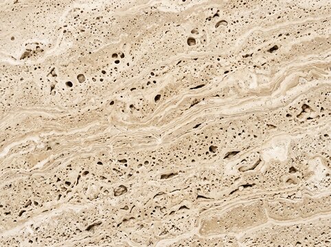 Close-up of natural travertine stone texture with porous surface. High-resolution beige limestone pattern for architectural design and decor.
