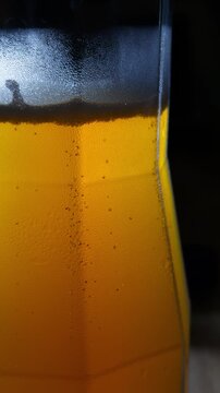Cold Beer Glass Bubbles Backlit Close-Up Macro Shot Golden Light