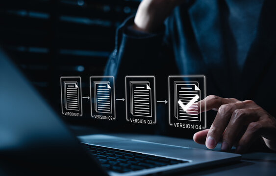 Document version control and revision history concept. Corporate manager editing digital files on laptop, change tracking, online document control, edit approval workflow, verified update