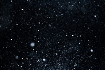 Fototapeta premium Particles of snow overlay on dark background. Falling snowflakes with winter storm motion. Snow texture overlay realistic snowfall. White snow layer with particles. Effect with drifting snow.
