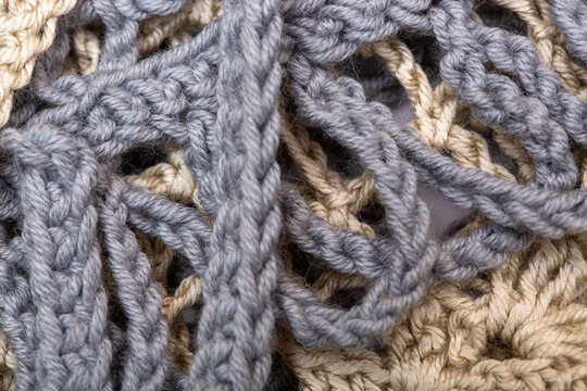Background from a fragment of a garment knitted with cotton yarn