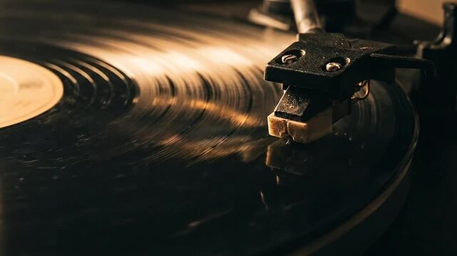 A close up view of a needle playing a black vinyl record on a turntable