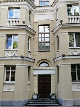 Vintage facade of residential or public building with ornate windows and mold