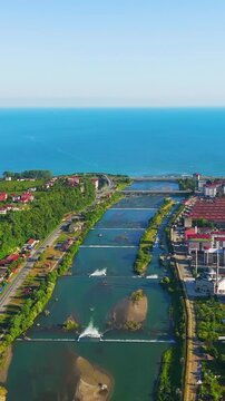 Vertical video. Ardeshen, Turkey. Firtina River Valley, aerial view over cascading weirs and red-roofed town stretching toward the Black Sea under clear morning light. Aerial View, MasterShots, Droni