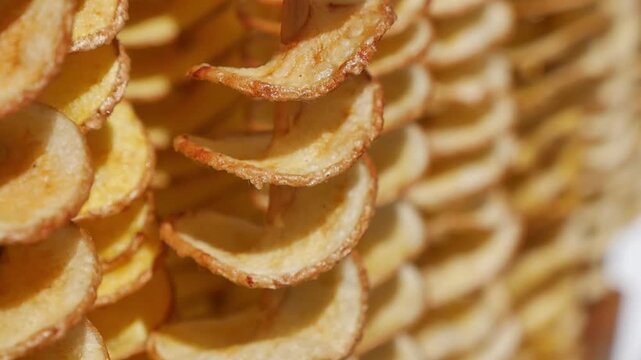 Chips made from fresh potatoes on a drying rack