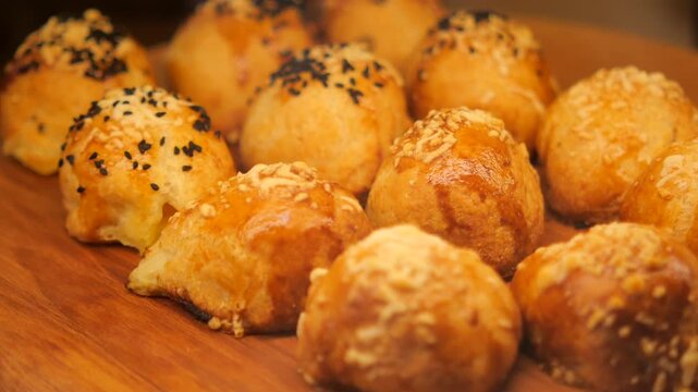 Freshly baked bread rolls on display at a bakery
