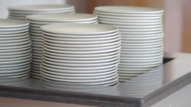 Stack of plates in a restaurant kitchen during lunch rush