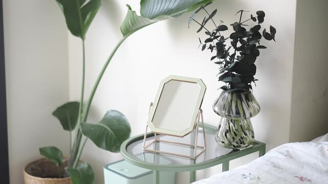Plant decor near a mirror on a bedside table
