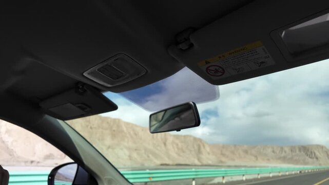 Car view driving along smooth modern G314 highway towards snow mountains near Karakul Lake Xinjiang