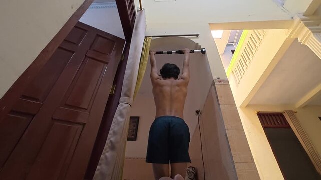 bar hang, passive hang, hanging exercise, grip strength, forearm endurance, back view, shirtless man, home workout, calisthenics, strength training, bodyweight exercise, doorway pull up bar, back musc