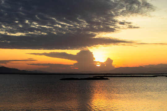 Sunset Over Calm Water with Dramatic Clouds