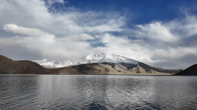 Scenic view of Muztagh Ata snow mountain reflection in dark waters of Karakul Lake Xinjiang China