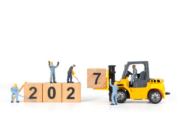 Miniature Workers and Forklift Changing Wooden Blocks from 2026 to 2027 New Year Concept © Sirichai Puangsuwan