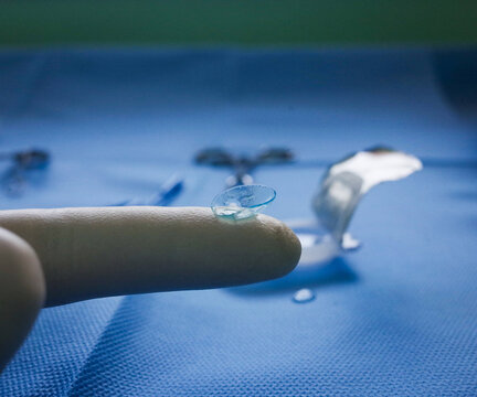 macro photo of contact lens on finger tip