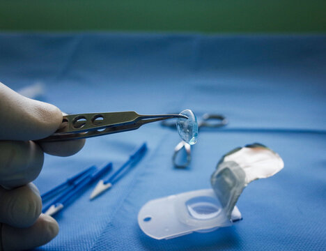 macro photo of contact lens hold by forceps