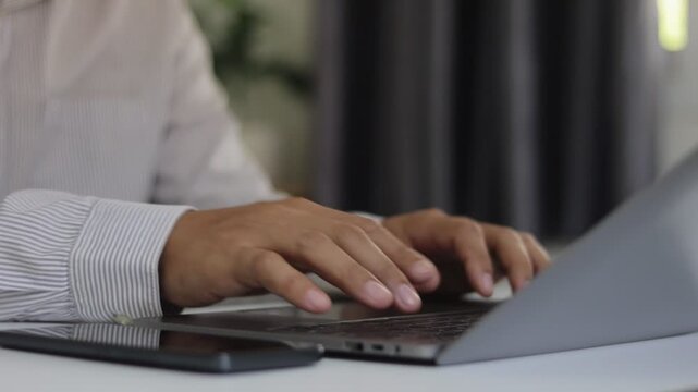 Close up of man hand finger swiping, typing, laptop browse internet at workplace. Businessman working digital device. freelancer scroll touchpad computer enjoy online job remote at home office.