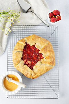 Rustic strawberry galette cooling on a wire rack
