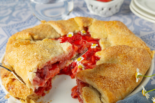 Slice of fresh strawberry galette being served