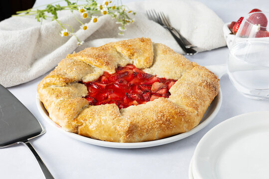 Beautiful rustic strawberry galette on a tabletop
