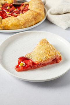 Slice of strawberry and chamomile galette on a plate