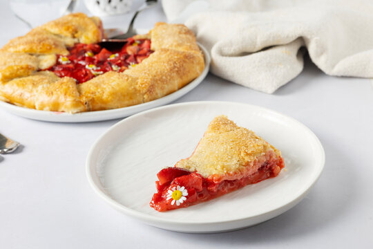 Slice of rustic strawberry galette on a plate