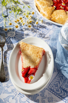 Slice of strawberry galette on a sunny day