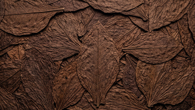 Dried brown tobacco leaves overlapping texture background