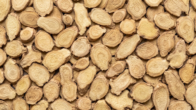Sliced dried astragalus root texture background