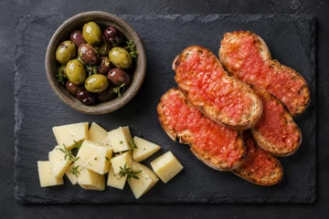 Traditional tomato toast with olive and cheese on stone slate. Appetizer from Spanish cuisine for Mediterranean diet. Tasty meal with bread, fresh tomato, raw cheese and salty olive. © Anzhelika