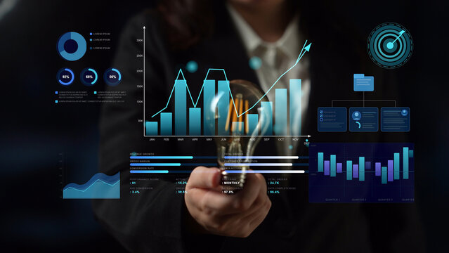 Business Professional Holding Light Bulb with Digital Graphs and Charts Representing Ideas and Innovation