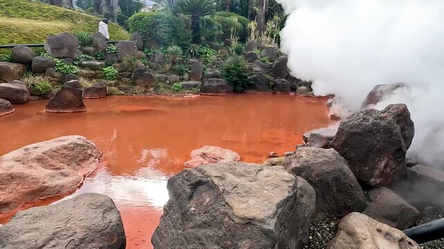 Landscape Umi Jigoku is largest among the Beppu Jigoku hot springs. The beautiful cobalt blue color is due to iron sulphate in the hot spring water Beppu Oita Japan - Smoke Footage Nature 