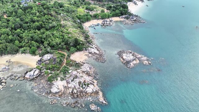 Scenic Aerial View Across Turun Aban Beach Bangka Highlighting Tropical Coastline Granite Reefs Shallow Waters Hidden Paradise and Natural Charm