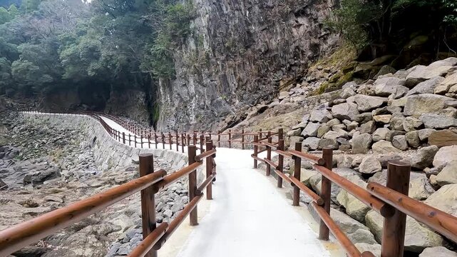 Landscape Takachiho Gorge is River canyon with waterfalls over sheer basalt cliffs viewable from rented boats and a paved path in Takachiho Miyazaki Kyushu Japan - Footage Clip Travel Nature