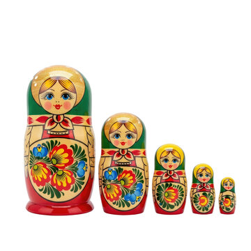 A row of five traditional Russian matryoshka nesting dolls standing in size order.