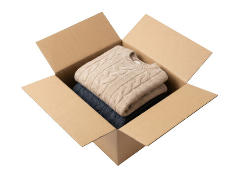 Two folded sweaters inside a cardboard box isolated on transparent background